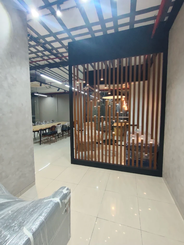 Office meeting room enclosed by a lit timber-slat partition